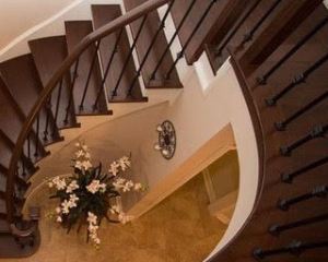 Circular stair case-custom make nosing-hardwood installtion-metal spindles-wood posts-shelf-landing-white stringers-curved nosing installation in Mississauga