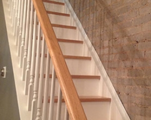 BOX STAIR-NEW WHITE STRINGERS-SOLID OAK-NATURAL FINISH-NEW OAK RAILING-BALL TOP POST-AFTER RENOVATION IN DOWN TOWN TORONTO